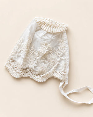 Delicate floral lace baby bonnet with tie straps