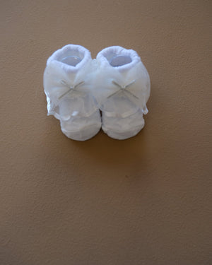 Newborn baby socks with decorative bows in pastel colors