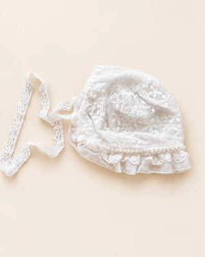 Delicate floral lace baby bonnet with tie straps