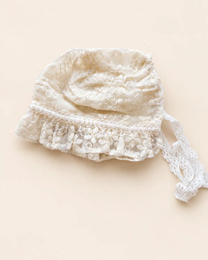 Delicate floral lace baby bonnet with tie straps
