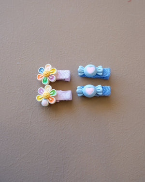 Assorted colorful decorative hair clips with bows, flowers, and playful motifs