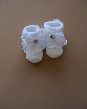 Newborn baby socks with decorative bows in pastel colors