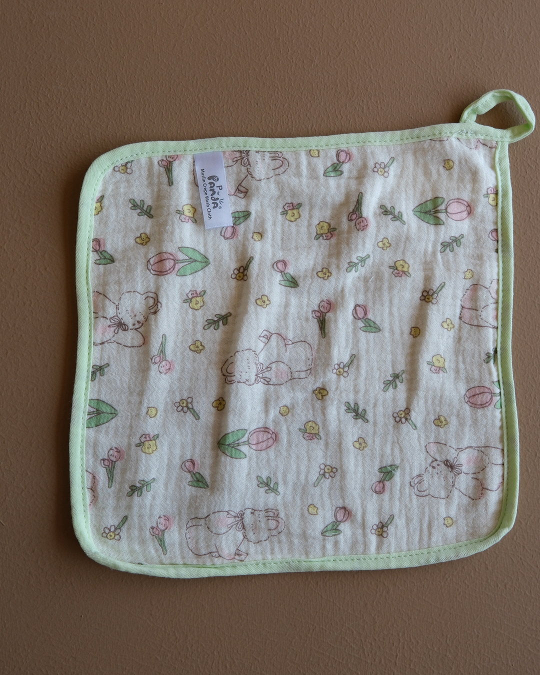 Assorted printed baby washcloths with colorful animal, floral, rainbow, and playful designs