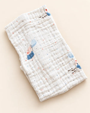 Printed muslin baby towel with playful elephant, unicorn, vehicle, and multicolor designs