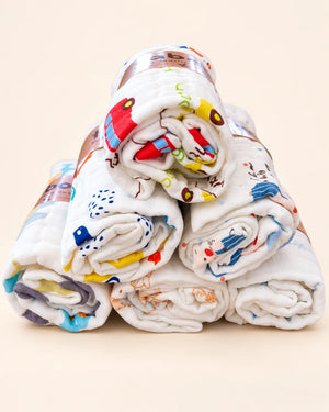 Printed muslin baby towel with playful elephant, unicorn, vehicle, and multicolor designs