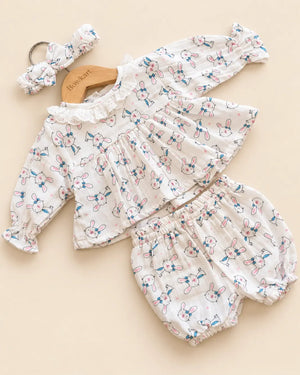 White bunny print baby clothing set with ruffled top, bloomers, and matching headband
