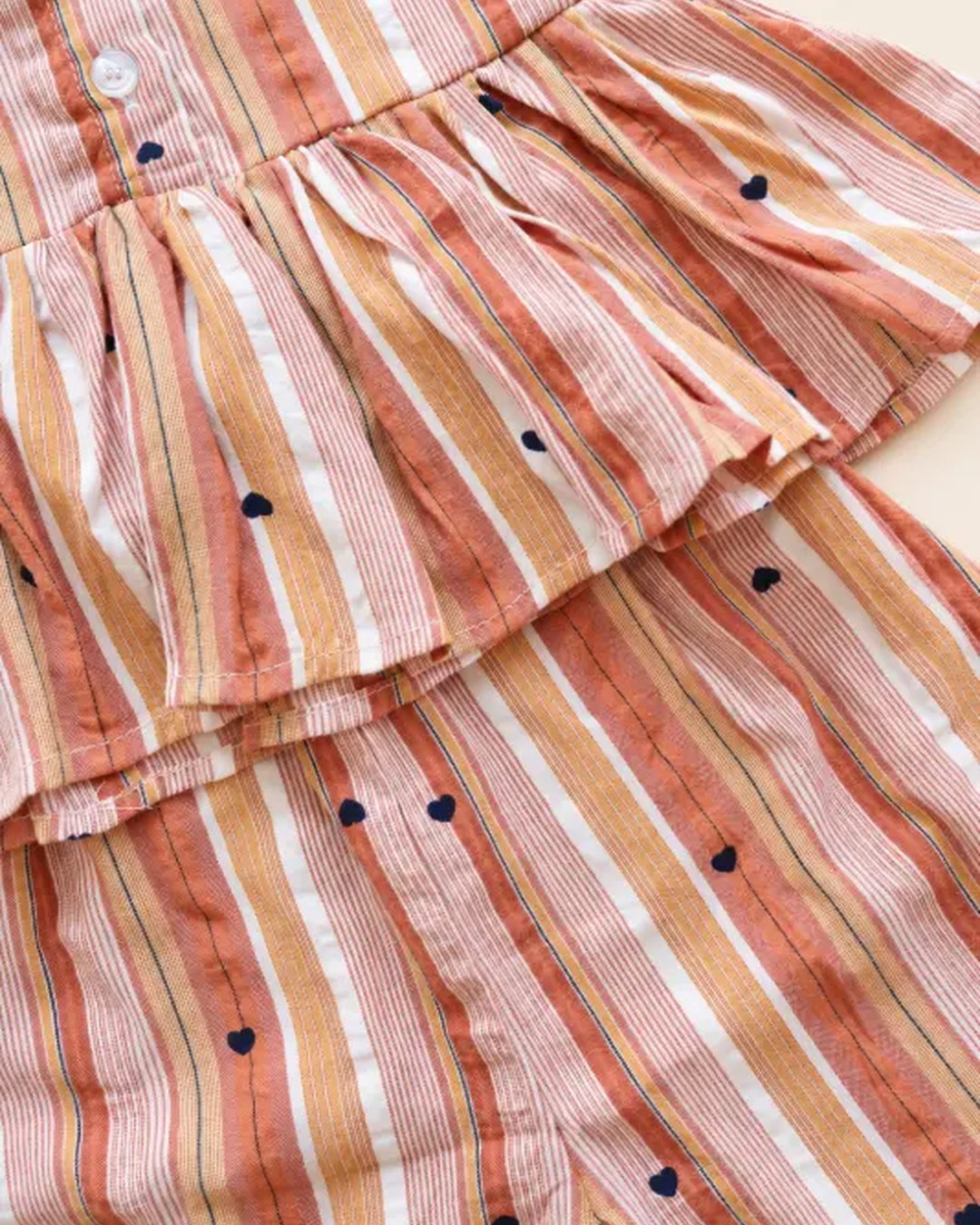 Striped girls frock set with heart motifs, ruffled sleeves, lace trim, and matching pants