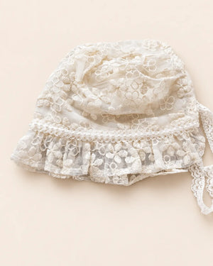 Delicate floral lace baby bonnet with tie straps