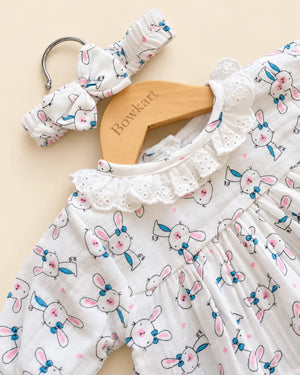 White bunny print baby clothing set with ruffled top, bloomers, and matching headband