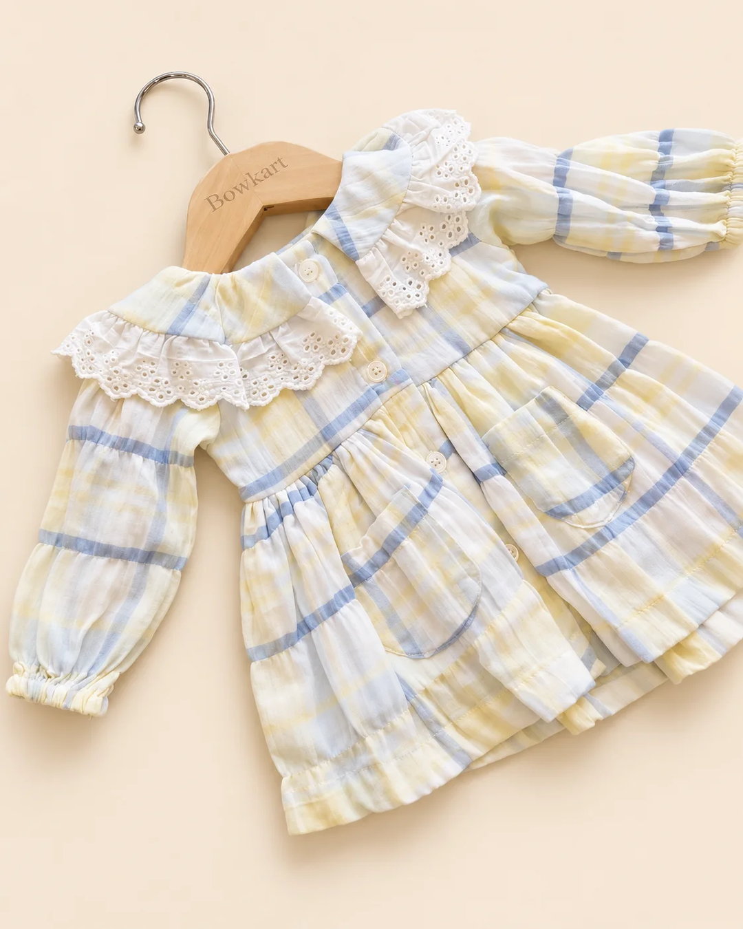 Pastel plaid girls' frock with lace-trimmed collar and long sleeves