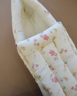 Ivory padded newborn sleeping bag with pink and green floral print