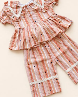Striped girls frock set with heart motifs, ruffled sleeves, lace trim, and matching pants