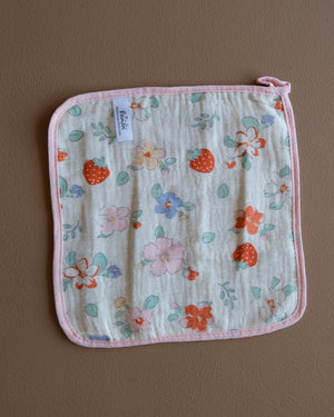 Assorted printed baby washcloths with colorful animal, floral, rainbow, and playful designs