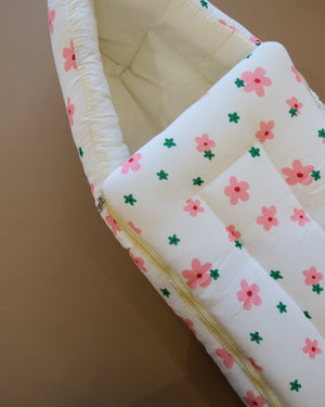 Ivory padded newborn sleeping bag with pink and green floral print