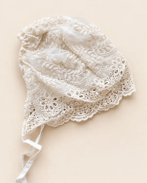 Delicate floral lace baby bonnet with tie straps