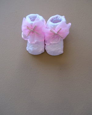 Newborn baby socks with decorative bows in pastel colors