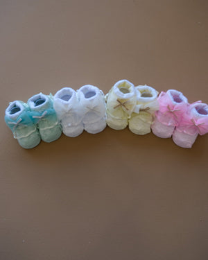 Newborn baby socks with decorative bows in pastel colors