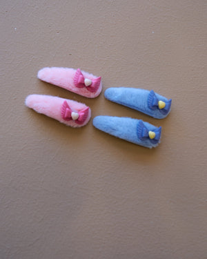 Assorted colorful decorative hair clips with bows, flowers, and playful motifs