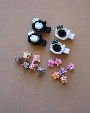 Assorted colorful decorative hair clips with bows, flowers, and playful motifs
