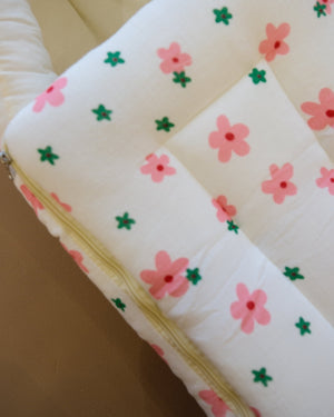 Ivory padded newborn sleeping bag with pink and green floral print