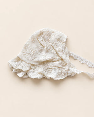 Delicate floral lace baby bonnet with tie straps