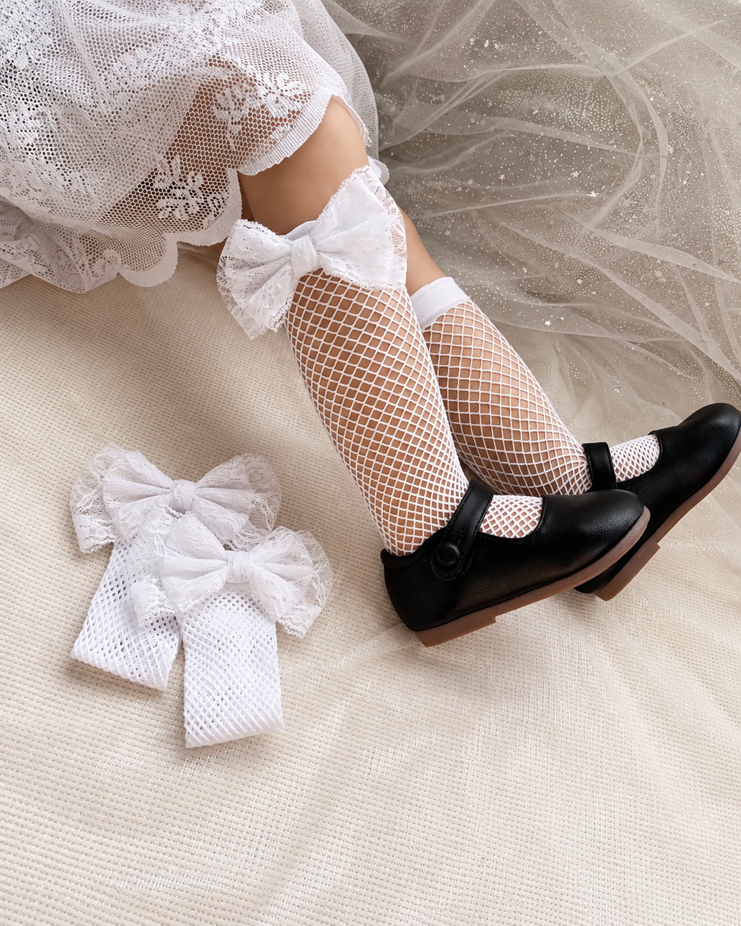 Children's fishnet stockings with oversized lace bows in black and white