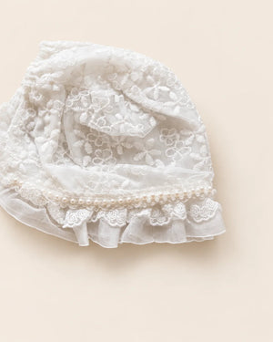 Delicate floral lace baby bonnet with tie straps