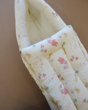 Ivory padded newborn sleeping bag with pink and green floral print