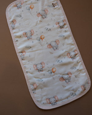 Printed off-white baby burp cloth with playful animal motifs and rounded edges
