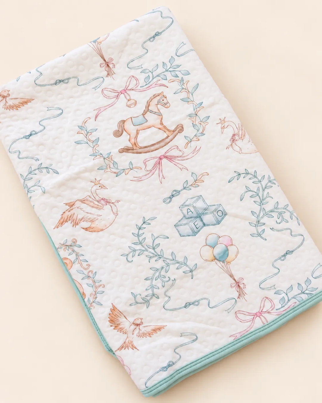 Printed white baby dry sheet with quilted texture and playful nursery illustrations