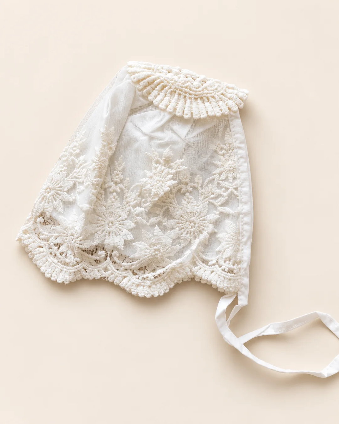 Delicate floral lace baby bonnet with tie straps
