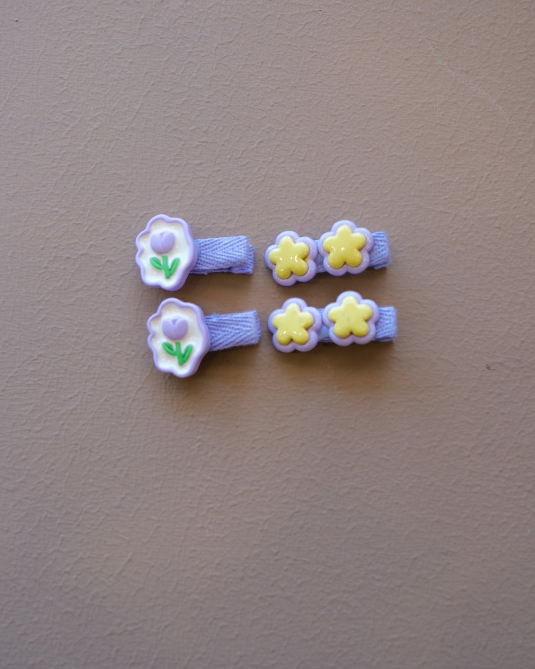 Assorted colorful decorative hair clips with bows, flowers, and playful motifs