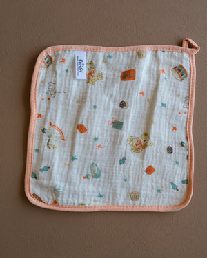 Assorted printed baby washcloths with colorful animal, floral, rainbow, and playful designs