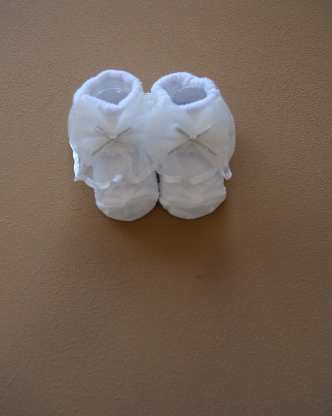 Newborn baby socks with decorative bows in pastel colors