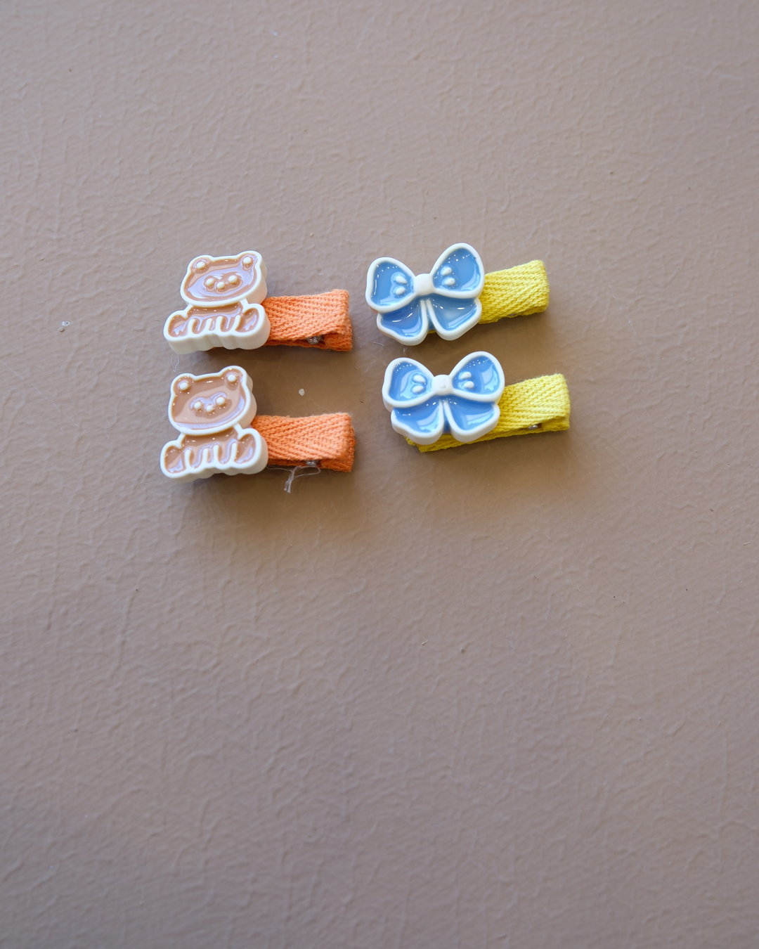 Assorted colorful decorative hair clips with bows, flowers, and playful motifs