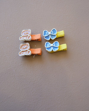 Assorted colorful decorative hair clips with bows, flowers, and playful motifs