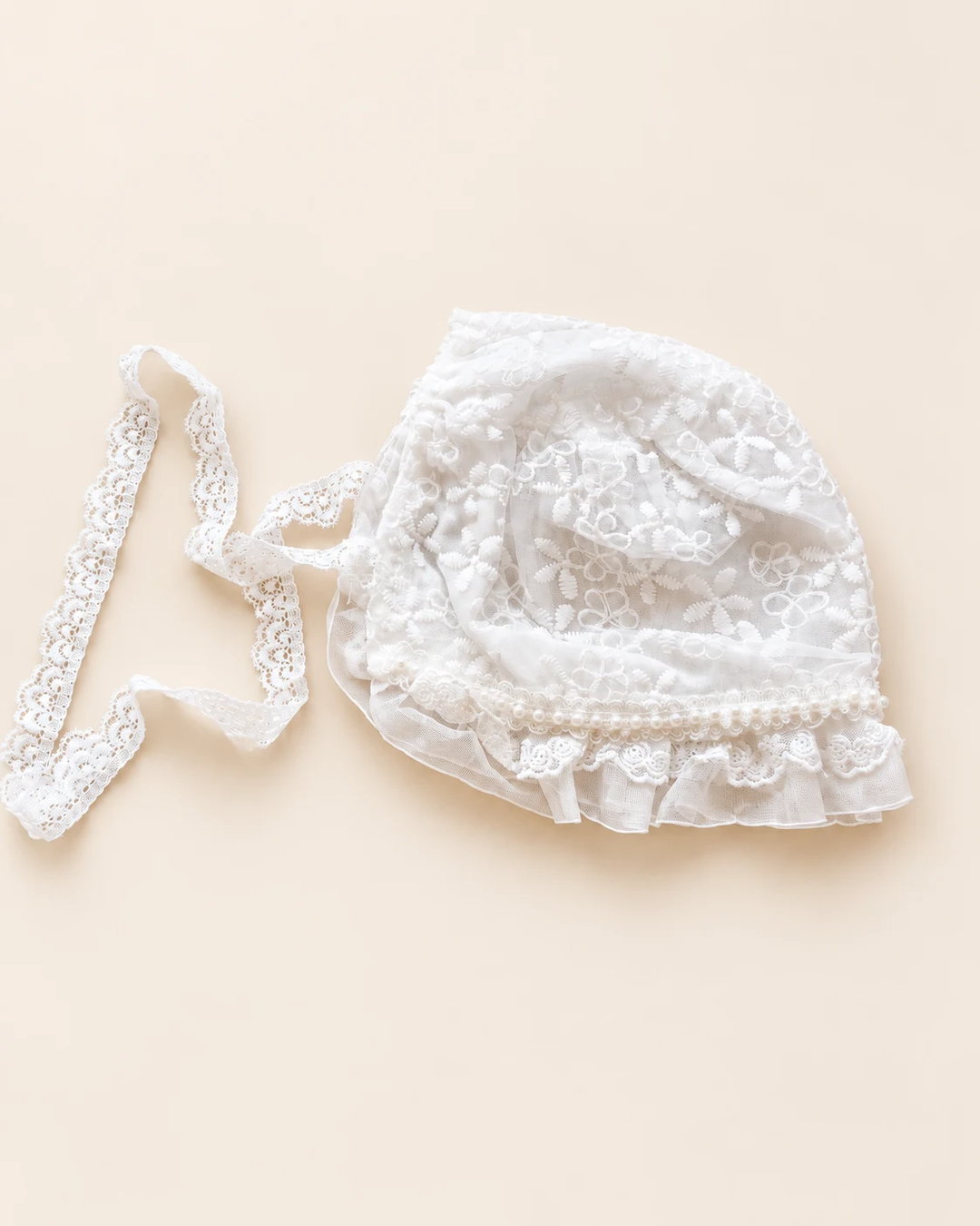 Delicate floral lace baby bonnet with tie straps