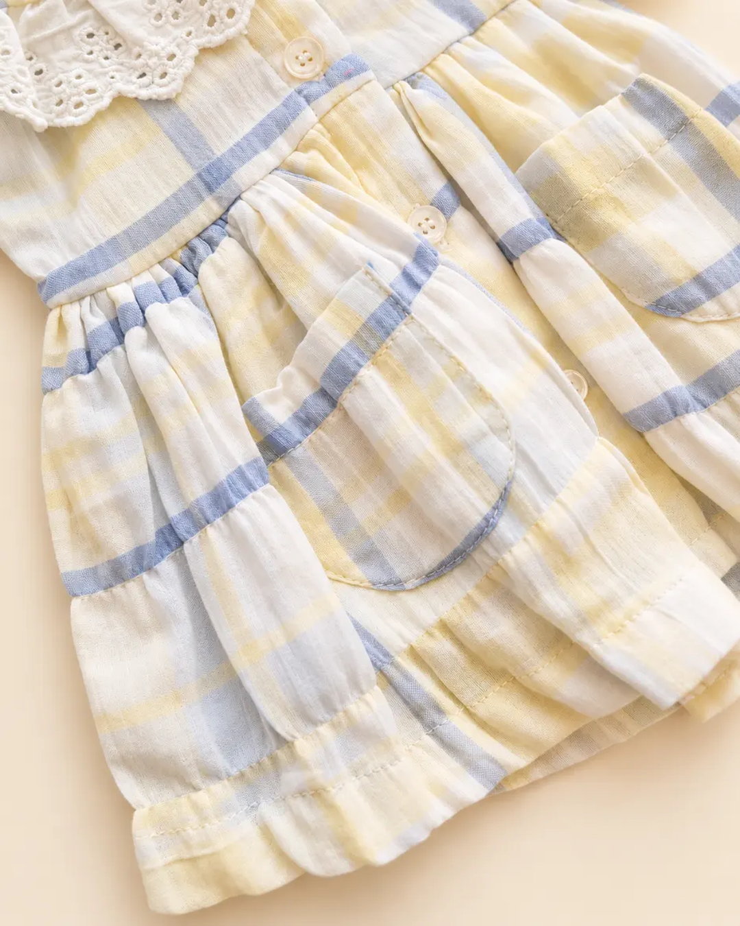 Pastel plaid girls' frock with lace-trimmed collar and long sleeves