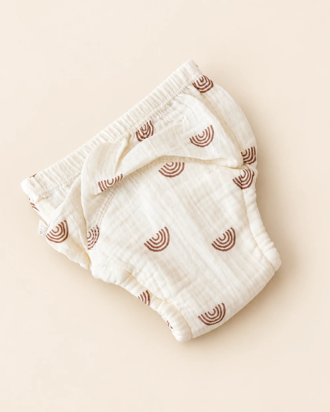 Reusable off-white cloth diaper with playful printed designs