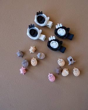 Assorted colorful decorative hair clips with bows, flowers, and playful motifs