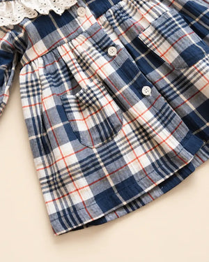 Navy blue plaid girls' frock with eyelet lace collar, long sleeves, buttons, and front pockets