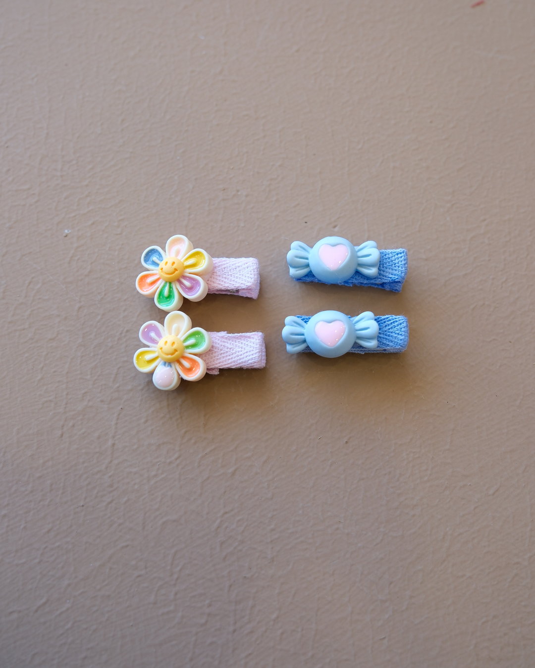 Assorted colorful decorative hair clips with bows, flowers, and playful motifs