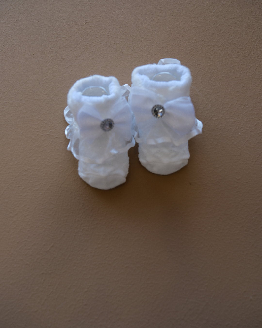 Newborn baby socks with decorative bows in pastel colors