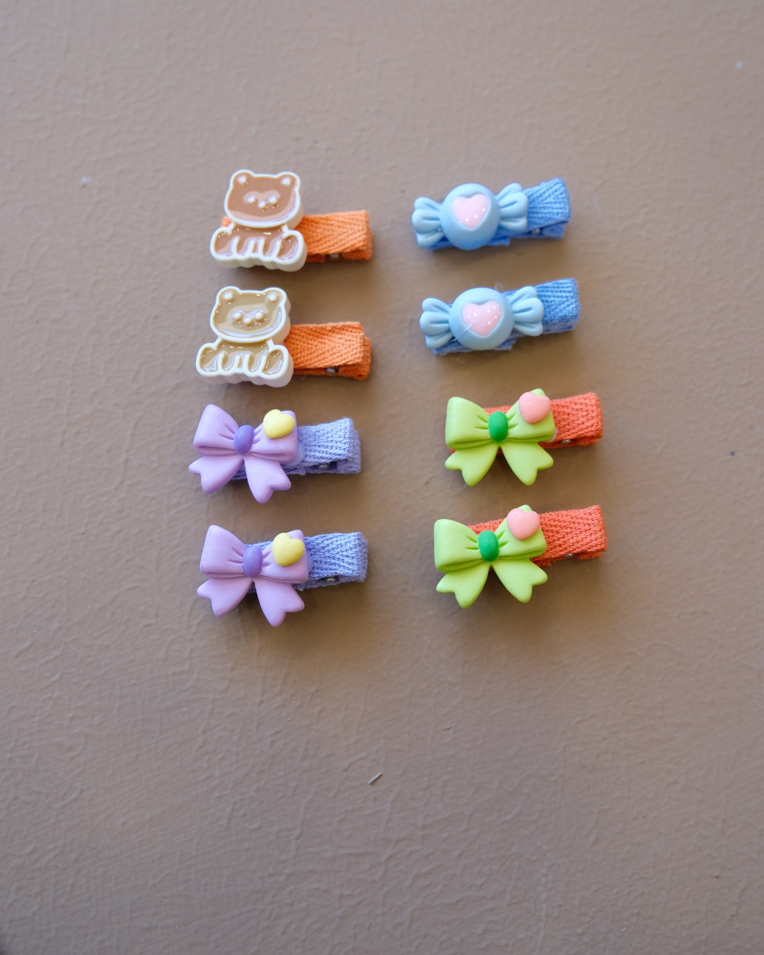 Assorted colorful decorative hair clips with bows, flowers, and playful motifs