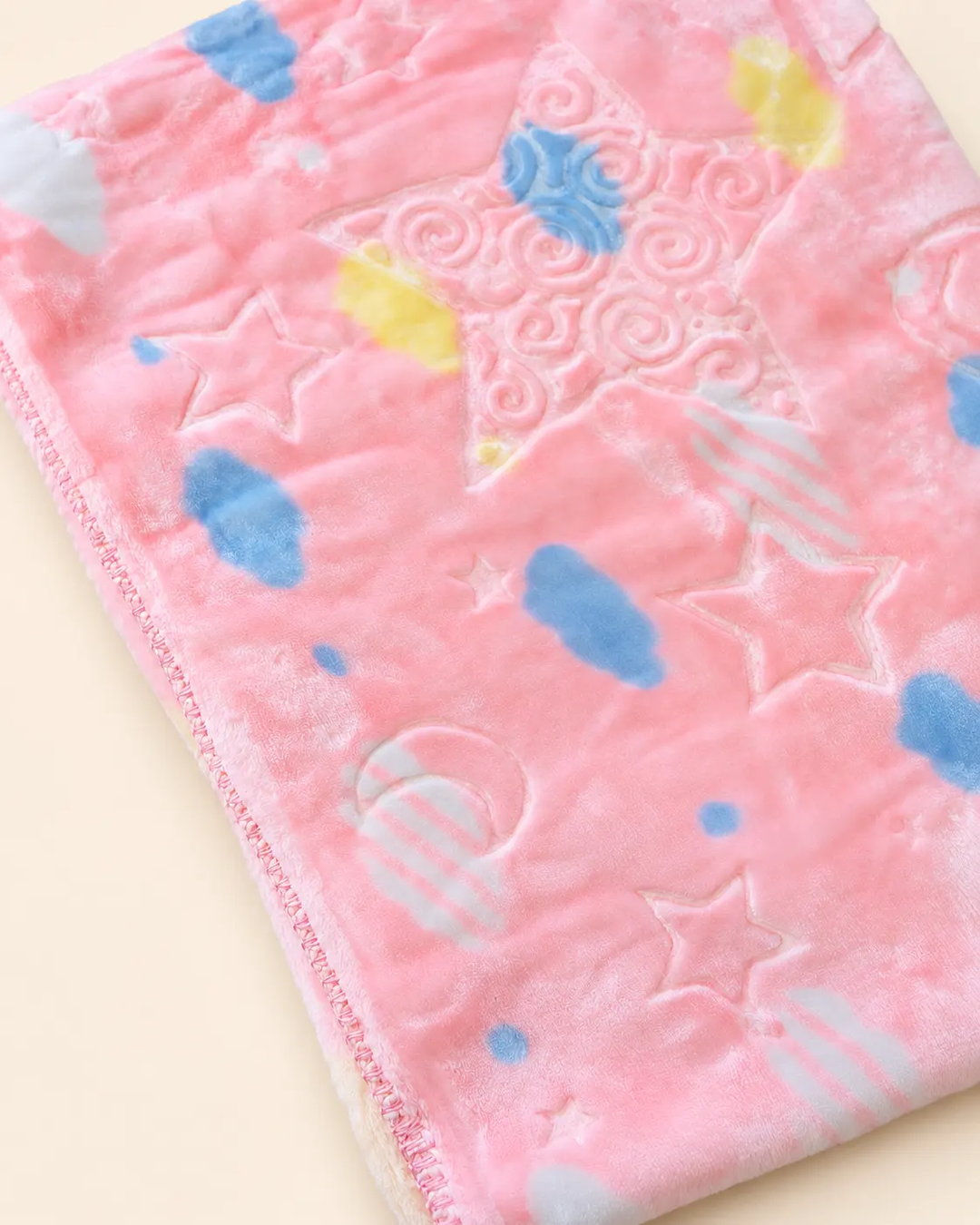 Blue and pink baby blanket with star, moon and cloud patterns