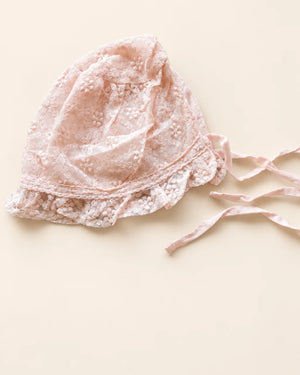 Delicate floral lace baby bonnet with tie straps