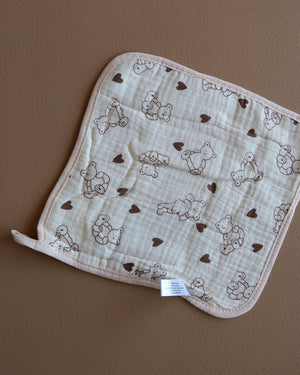 Assorted printed baby washcloths with colorful animal, floral, rainbow, and playful designs
