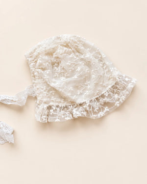 Delicate floral lace baby bonnet with tie straps