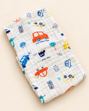 Printed muslin baby towel with playful elephant, unicorn, vehicle, and multicolor designs