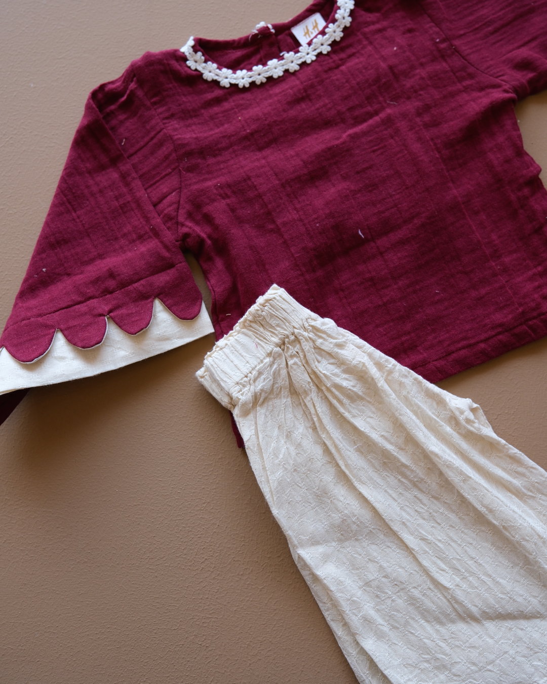 Girls' purple floral-trim top with coordinating off-white pants